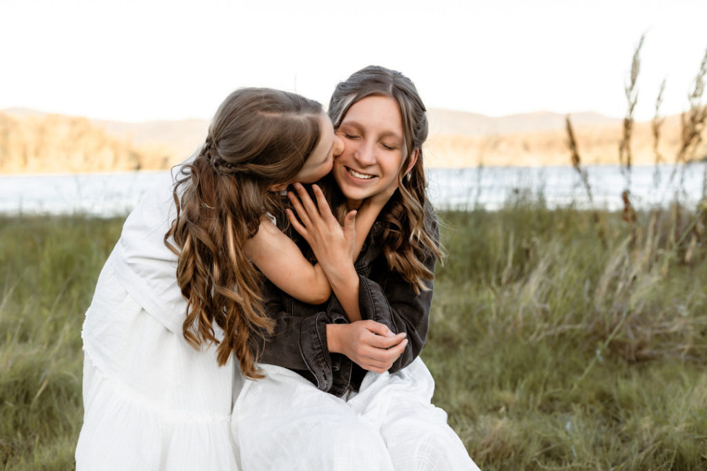 Two sisters having a beautiful time at their family phtooshoot