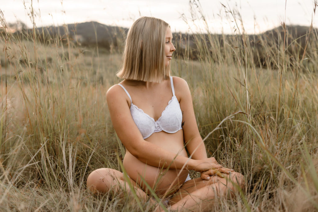 Pregnant Mama in lace bra, showing off her baby bump during a Golden Hour Photo Session.