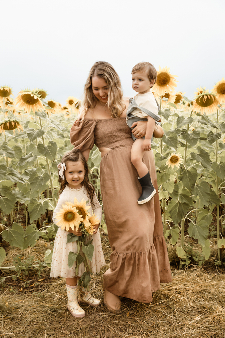 Rainy Day photography - Mama and kids in the sunflower festival field of unflowers