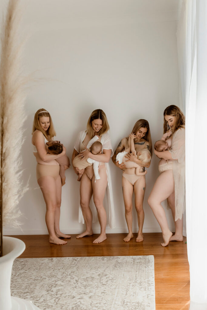 Four mums in nude clothing holding and breastfeeding their bubs. 