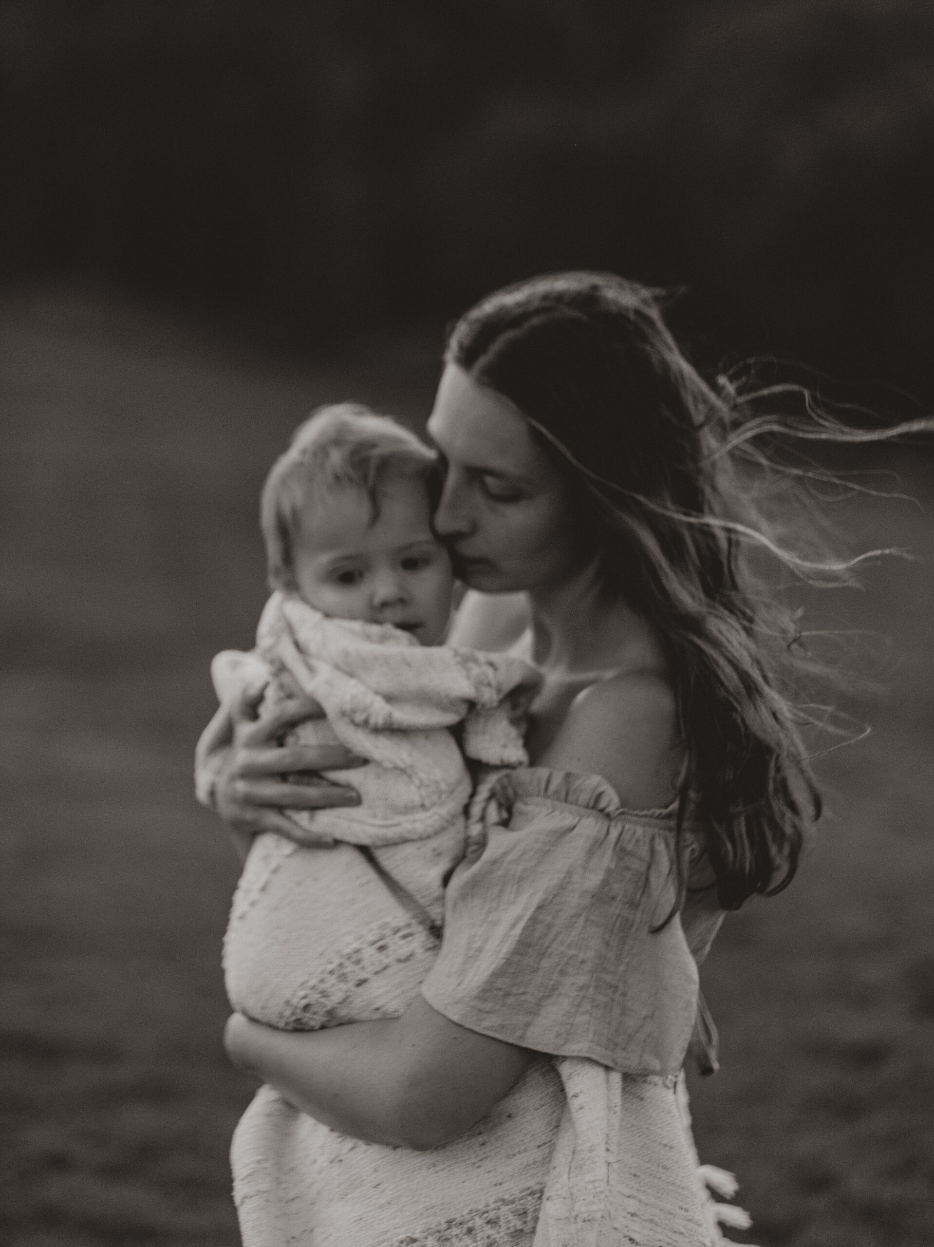 Courtney Blury, holding her daughter who is wrapped in a very warm blanket.